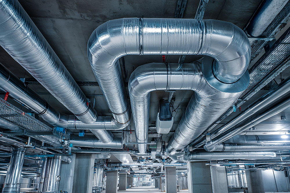 Modern HVAC ductwork system in industrial building, showcasing efficient heating and cooling solutions.
