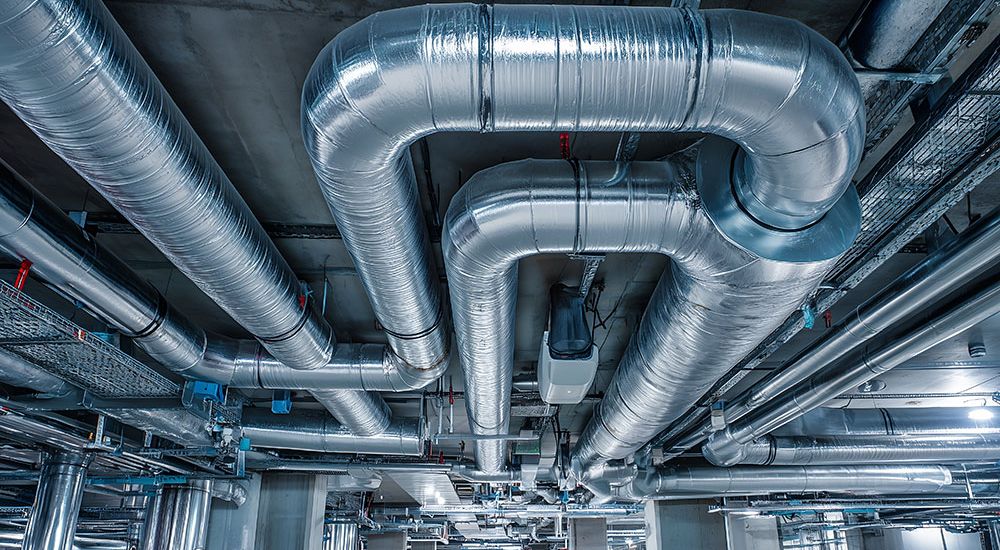 Modern HVAC ductwork system in industrial building, showcasing efficient heating and cooling solutions.